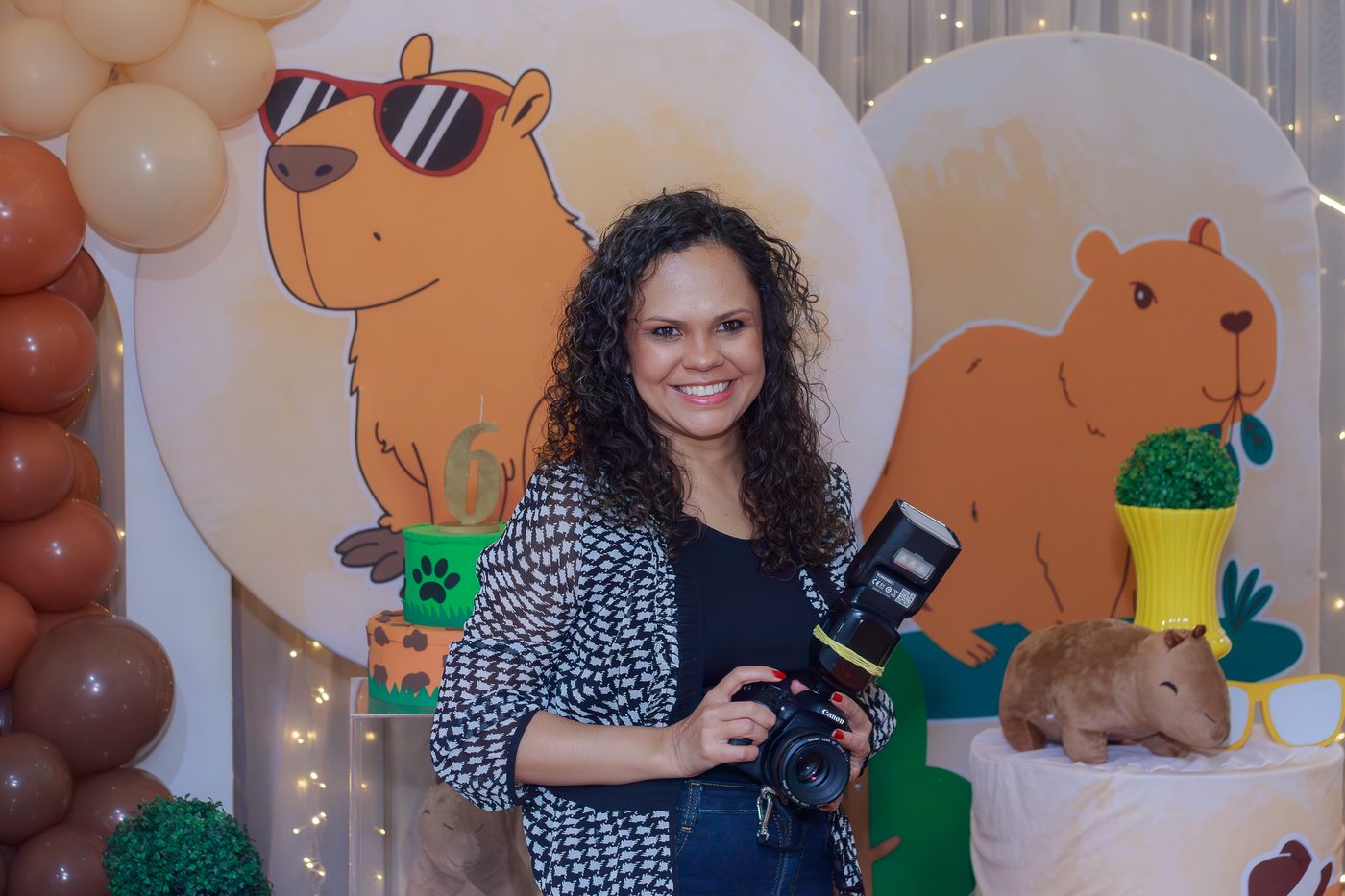Thassiana segurando uma câmera em um evento